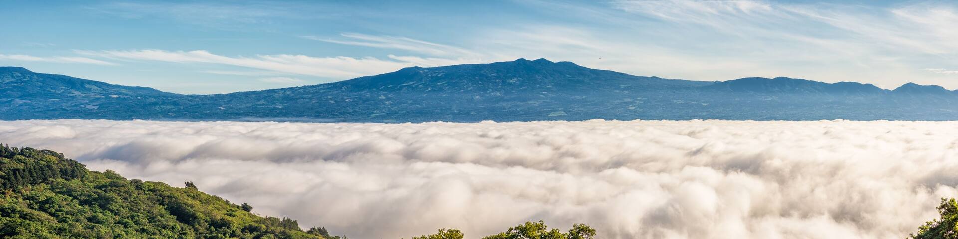 A mountain range with a cloud-covered valley below.