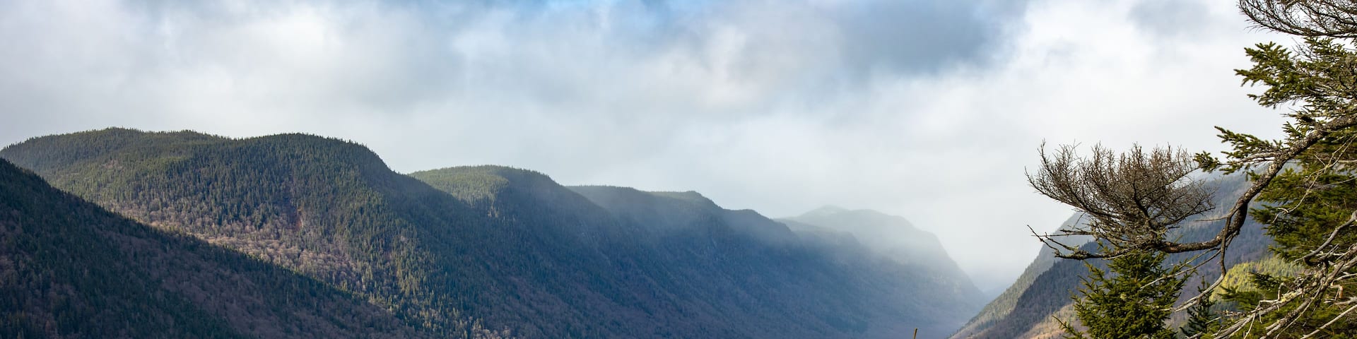 A river winding through a valley with mountains in the background.