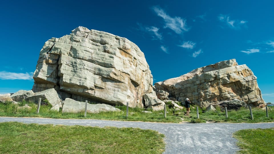 A large rock formation with a clear sky.
