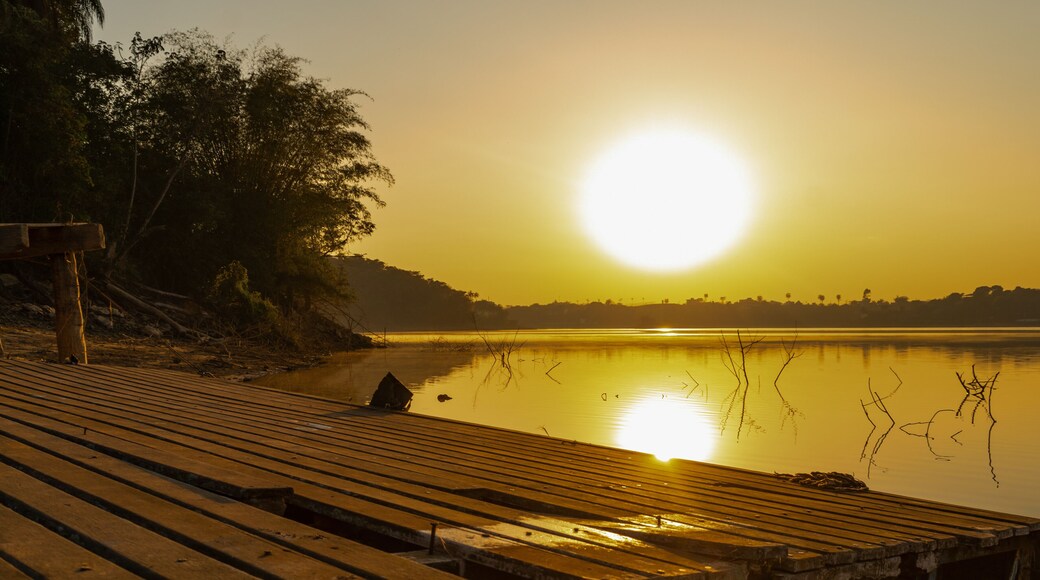 Beautiful sunrise over a small wooden pier and gallons, golden and clear sky, with fog on the freshwater beach of the Várzea das Flores dam, in Contagem, Minas Gerais, Brazil.