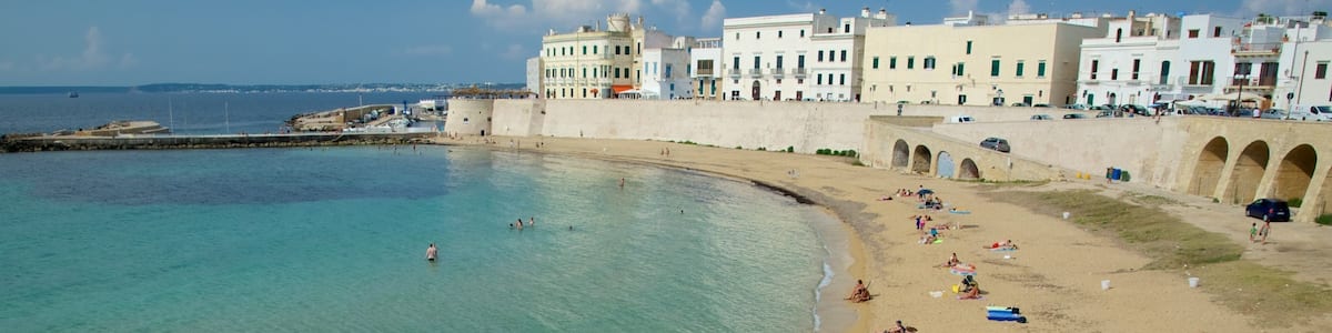 Lecce which includes a coastal town, a beach and general coastal views