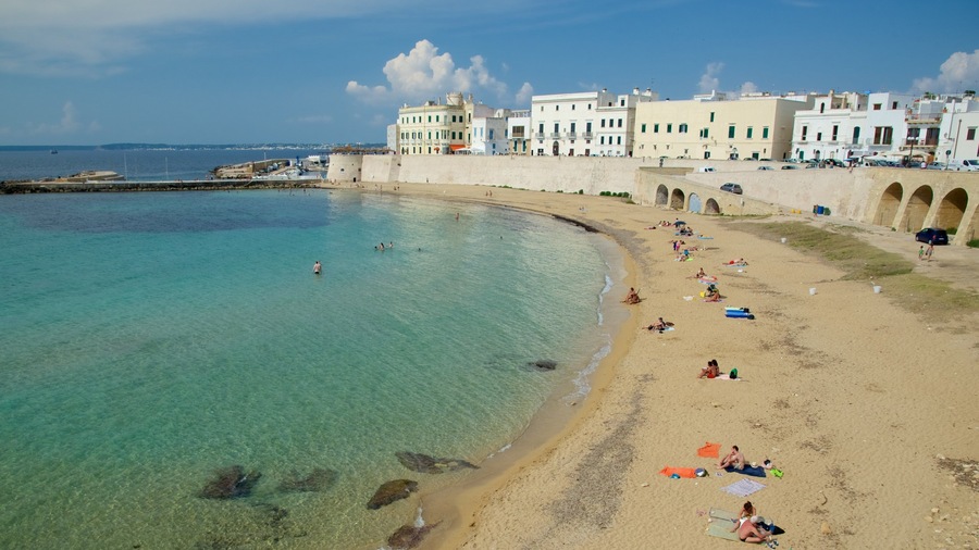Lecce showing a coastal town, general coastal views and a beach
