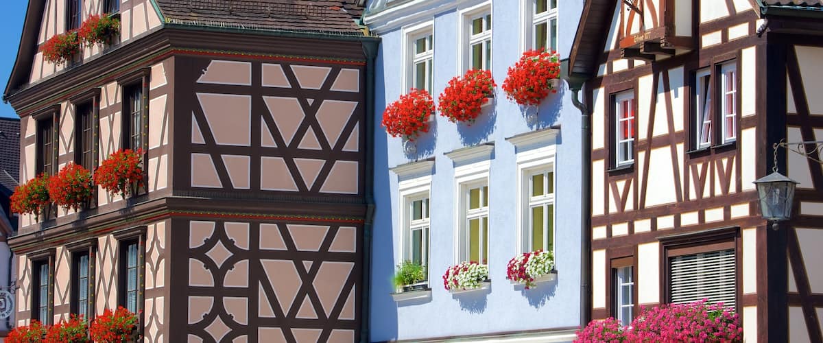 A traditional half-timbered building with colorful flower boxes on the windowsills.