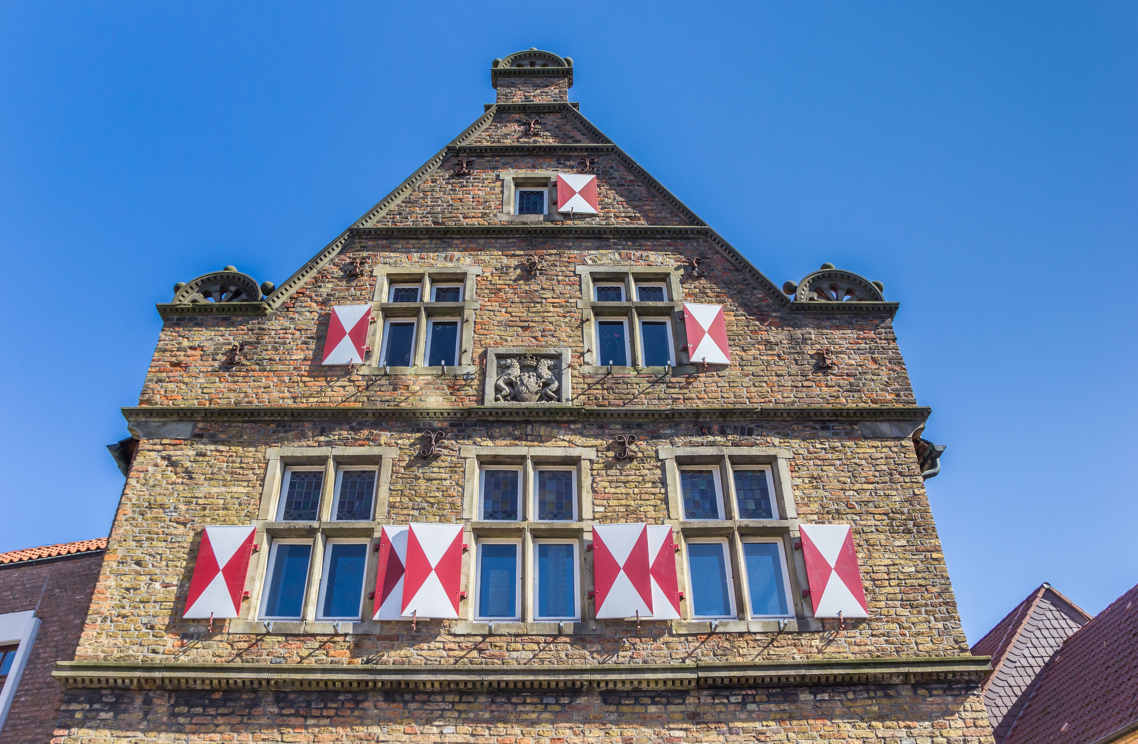 Hatches on the facade of an old house in Werne, Germany