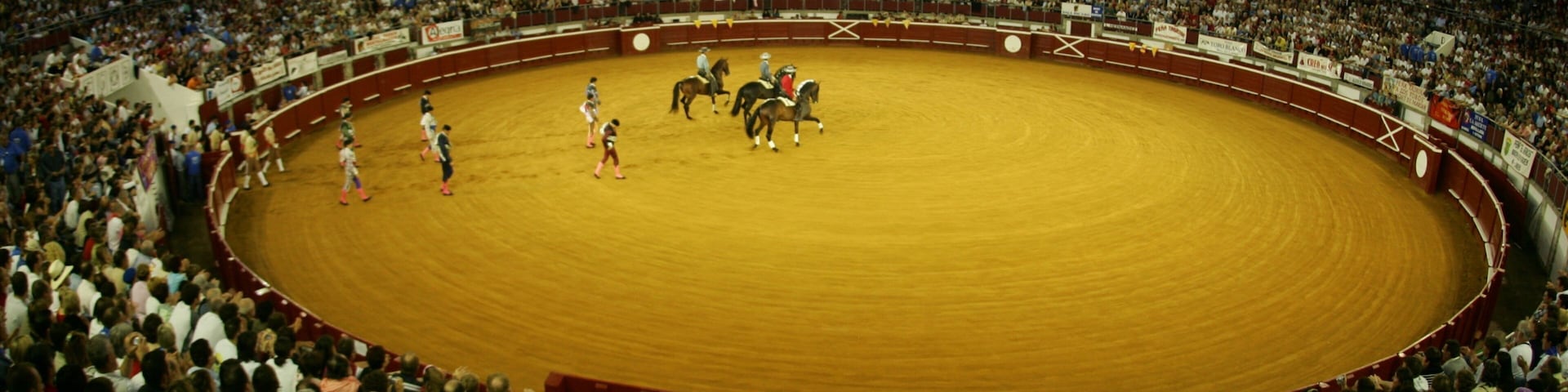 A bullfighting arena with a crowd of spectators.