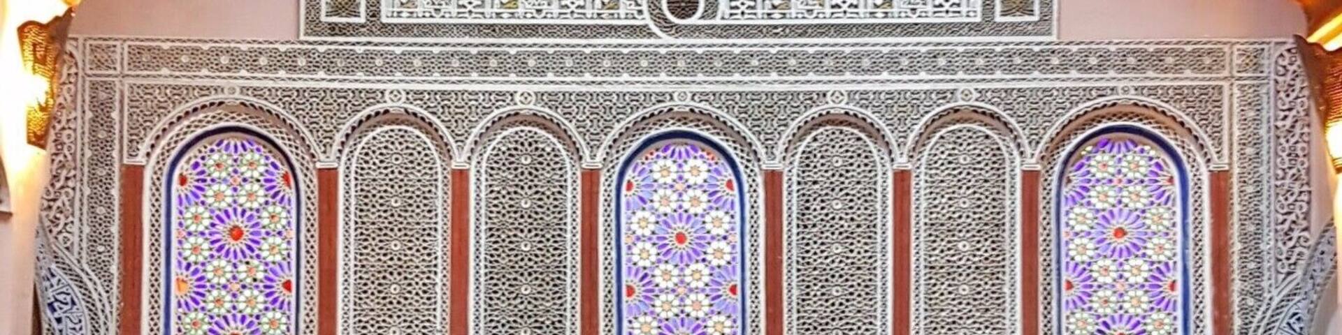 A room with intricate tile work, a sofa, and a coffee table.