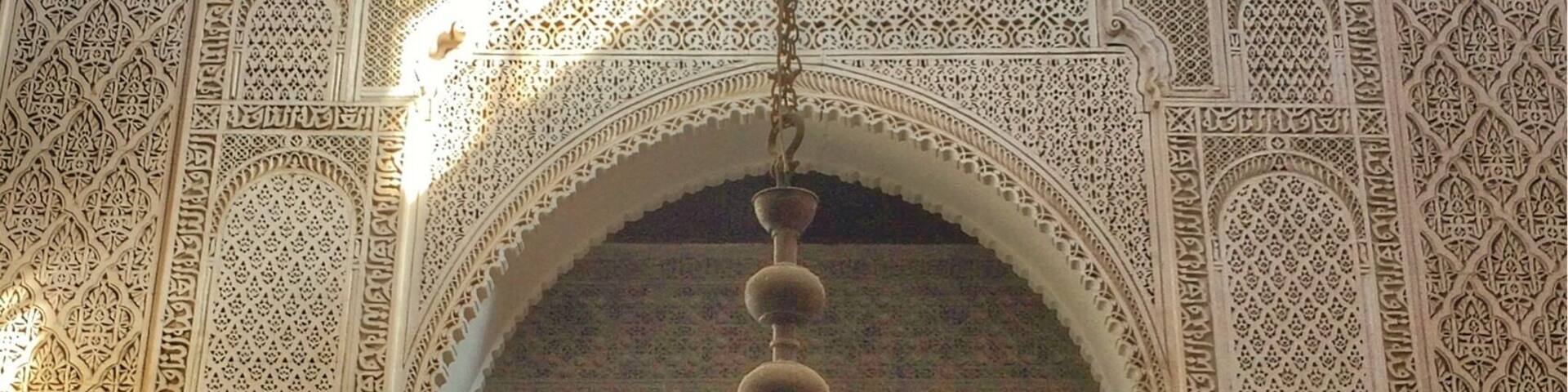 An ornate interior with intricate tile work and a large chandelier.