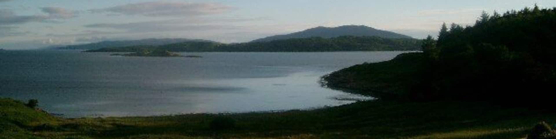Late evening from the Loch Melfort Hotel. Arduiane Gardens on the R; The Isle of Shuna in the middle distance; Jura far to the S.