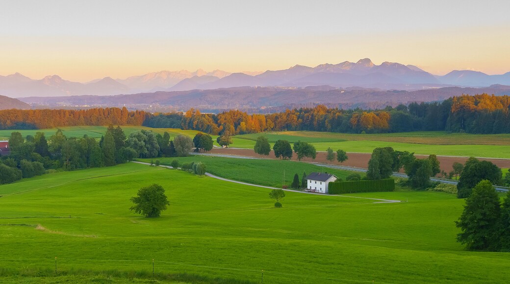 Wide panoramic view of the bavarian alps in germany with beautiful light during a summer sunset, as seen from Feldkirchen-Westerham, Bavaria.