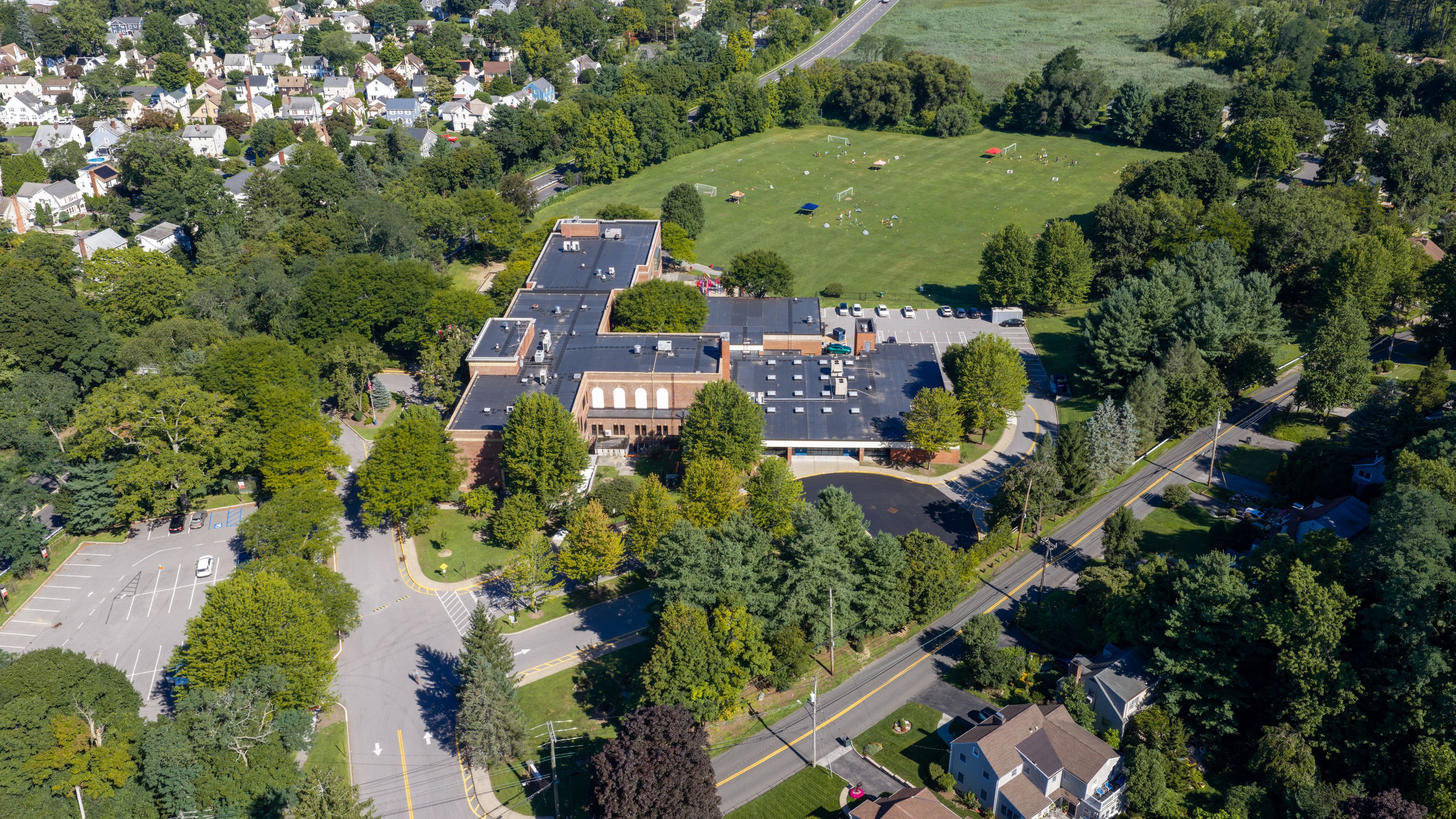 Residential properties surrounded by mature summer trees in White Plains, New York