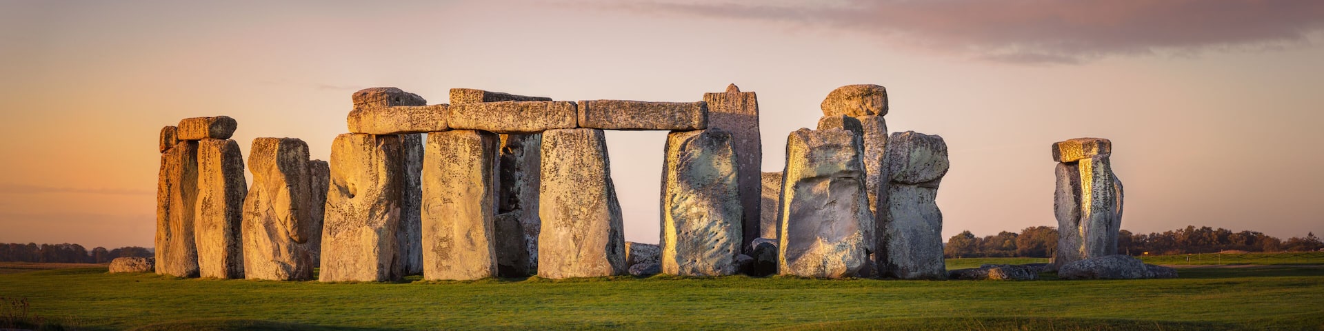 Beautiful panorama of Stonehenge during early morning. Sunrise glow seen on the historical landmark