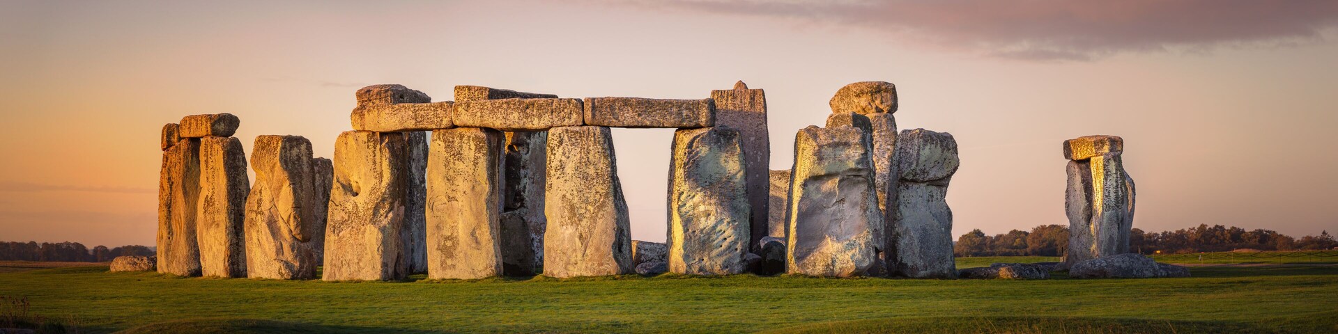 Stonehenge standing in a grassy field.
