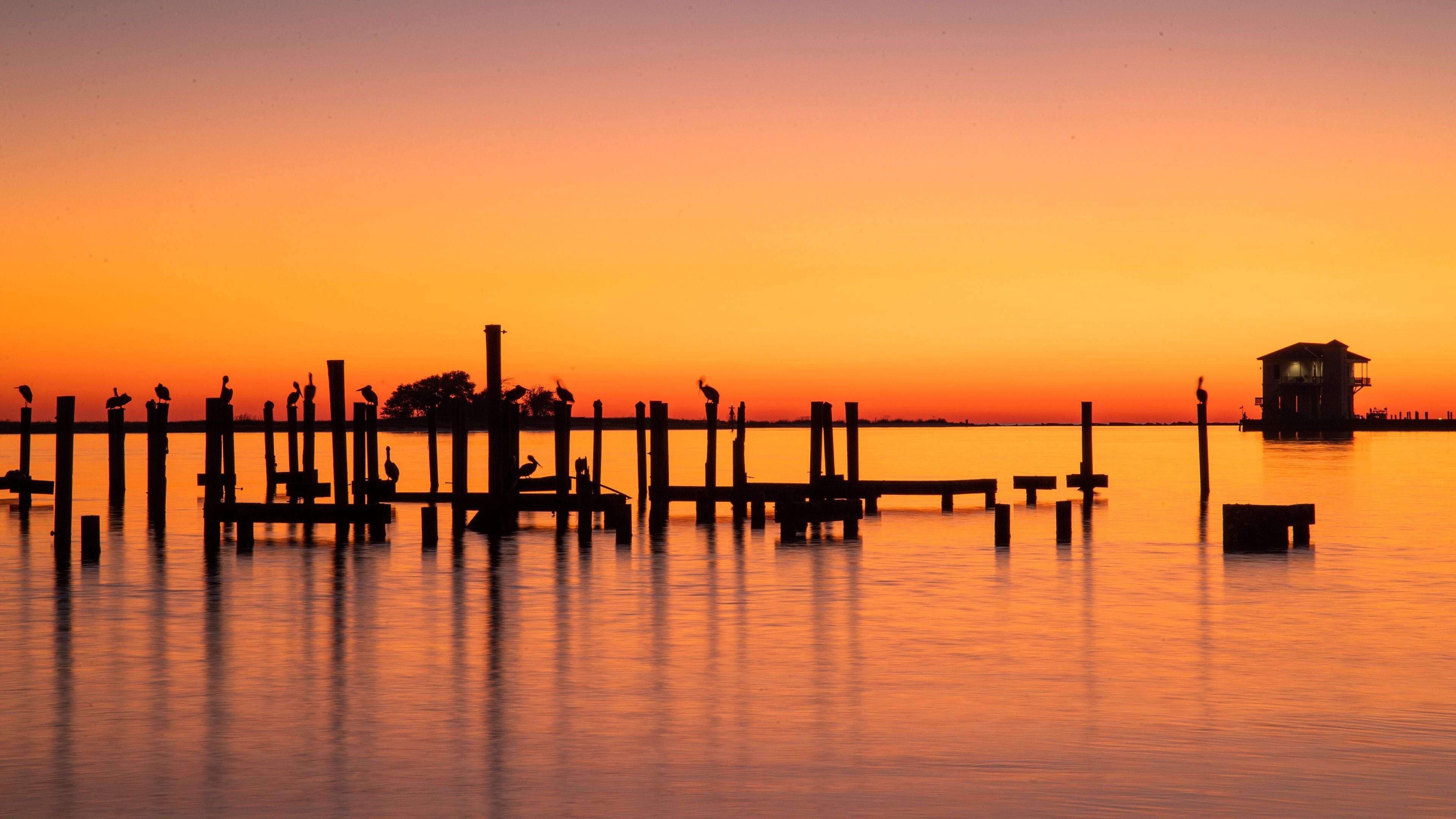 Biloxi which includes general coastal views and a sunset