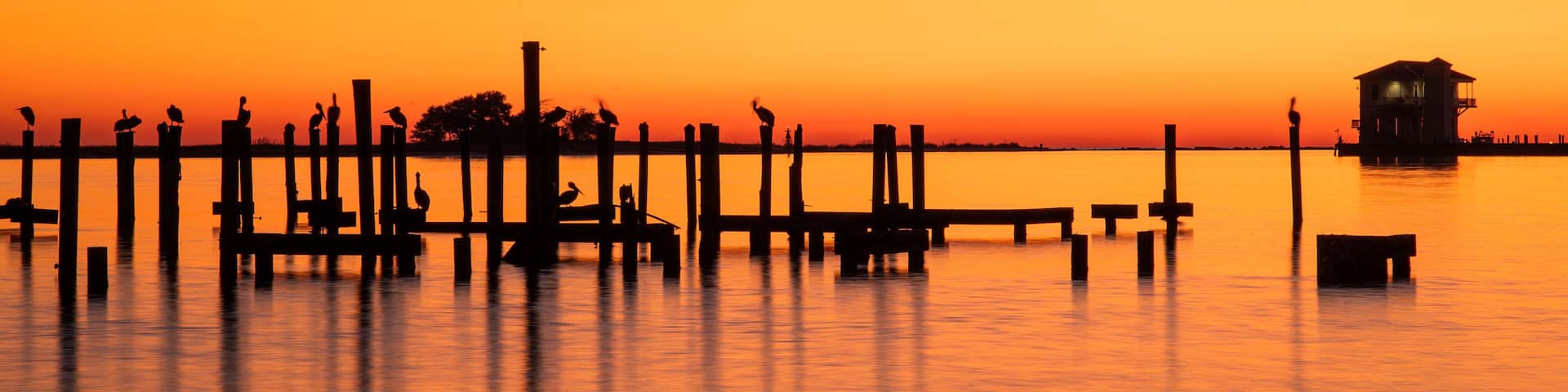 Biloxi which includes general coastal views and a sunset