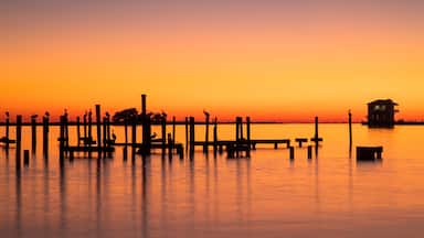 Biloxi which includes general coastal views and a sunset
