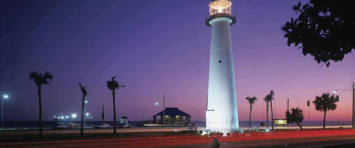 Biloxi featuring a lighthouse and night scenes