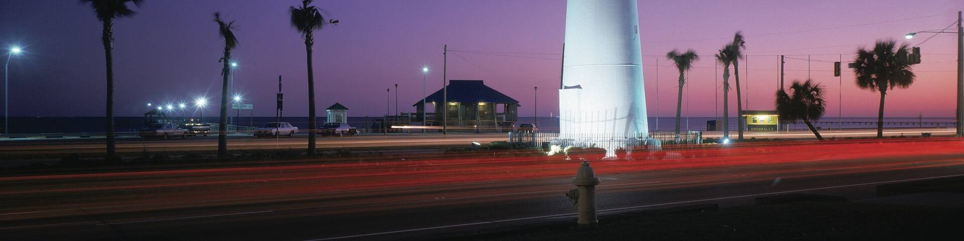 Biloxi featuring a lighthouse and night scenes