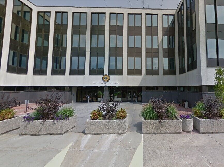 A modern building with large windows and a central entrance.