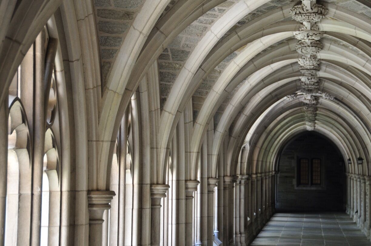 A long corridor with arched ceilings and columns.