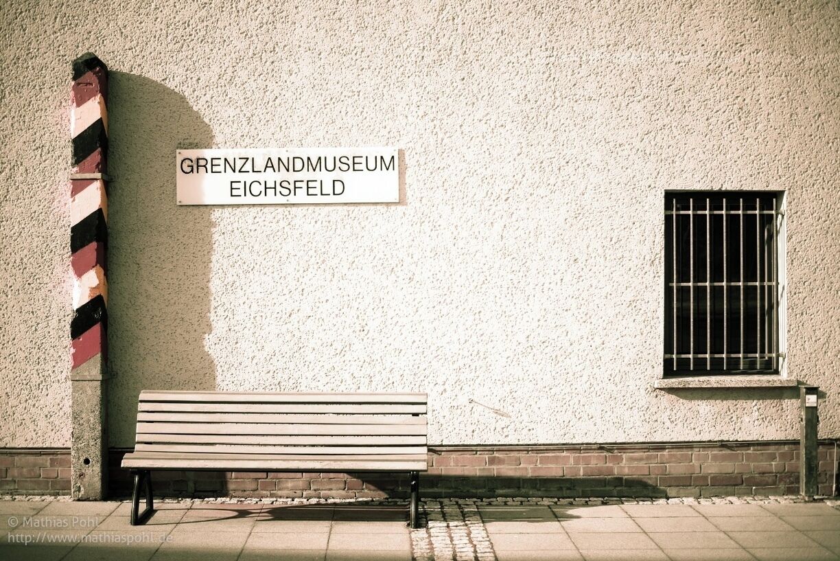Part#1 - The Museum
The Borderland Museum Eichsfeld combines a museum, study centre and outdoor trail along the line of the former border. It occupies the former East German customs building at the crossing point between Duderstadt and Teistungen. The permanent exhibition documents the history of the border in the Eichsfeld region, which was divided between East and West Germany during the Cold War. A trail follows the old border fortifications up to a West German observation tower which was constructed to allow people to look into East Germany.