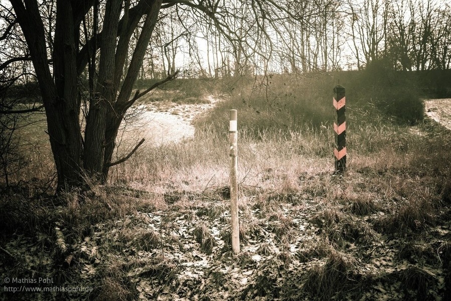 Part #10: Border Stones
The direct course of the border was demarcated by border stones. The border stone preserved here was right on the edge of a field while the border posts, visible from afar, were 1 - 2 m away from the border line, on east german territory. The border installation were always ata certain distance from the actual border line, at this point, this is over 50 m.
