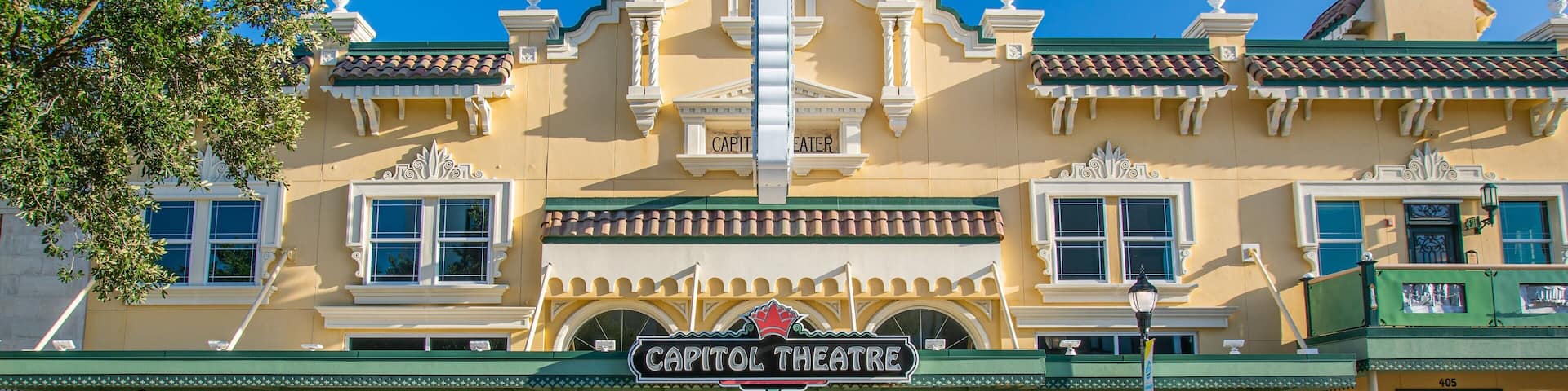 A yellow building with a sign that reads "Capitol Theatre".