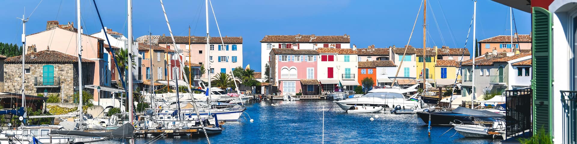 A view of Port Grimaud, provencal and mediterranean village on the French Riviera, in Provence-Alpes-Côte d'Azur, Var, south of France during a sunny summer day with a blue sky in the background