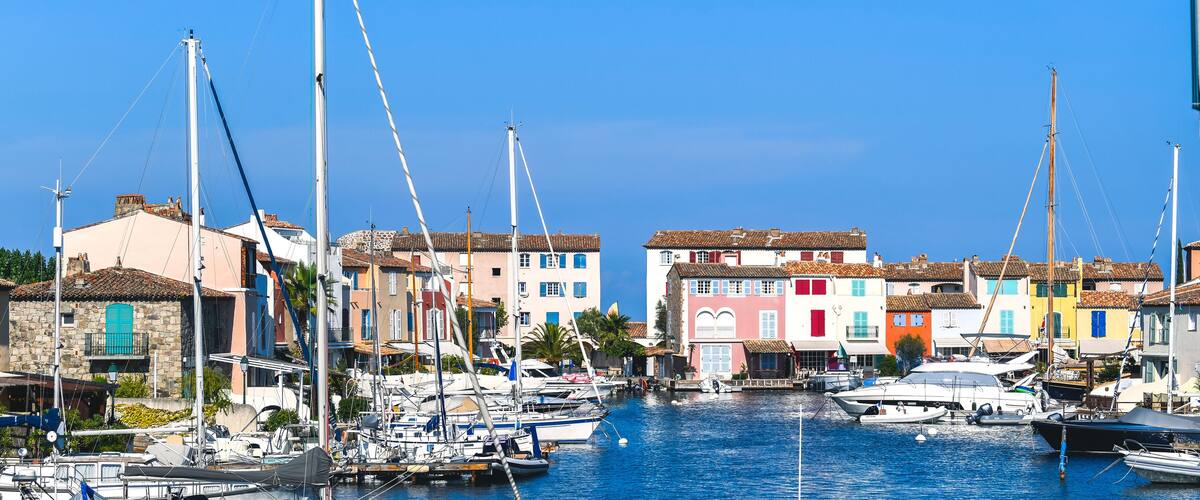 A marina with colorful buildings and boats docked.