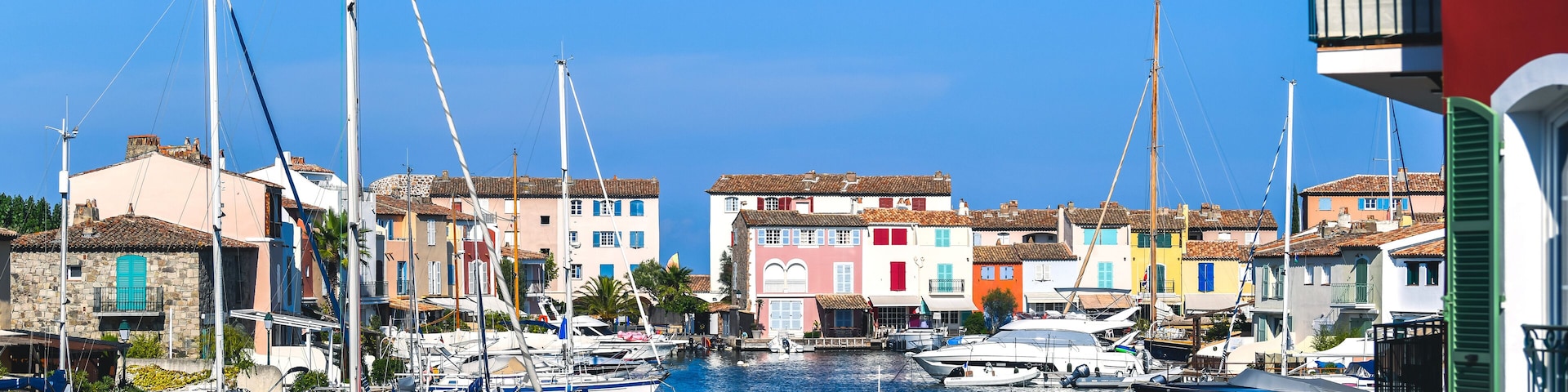 A marina with colorful buildings and boats docked.