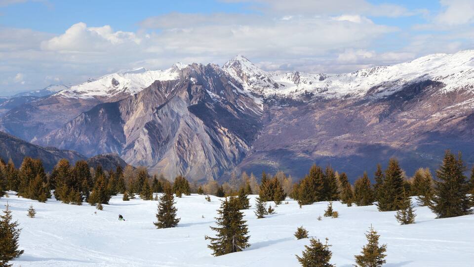 A snow-covered mountain range with a clear sky.