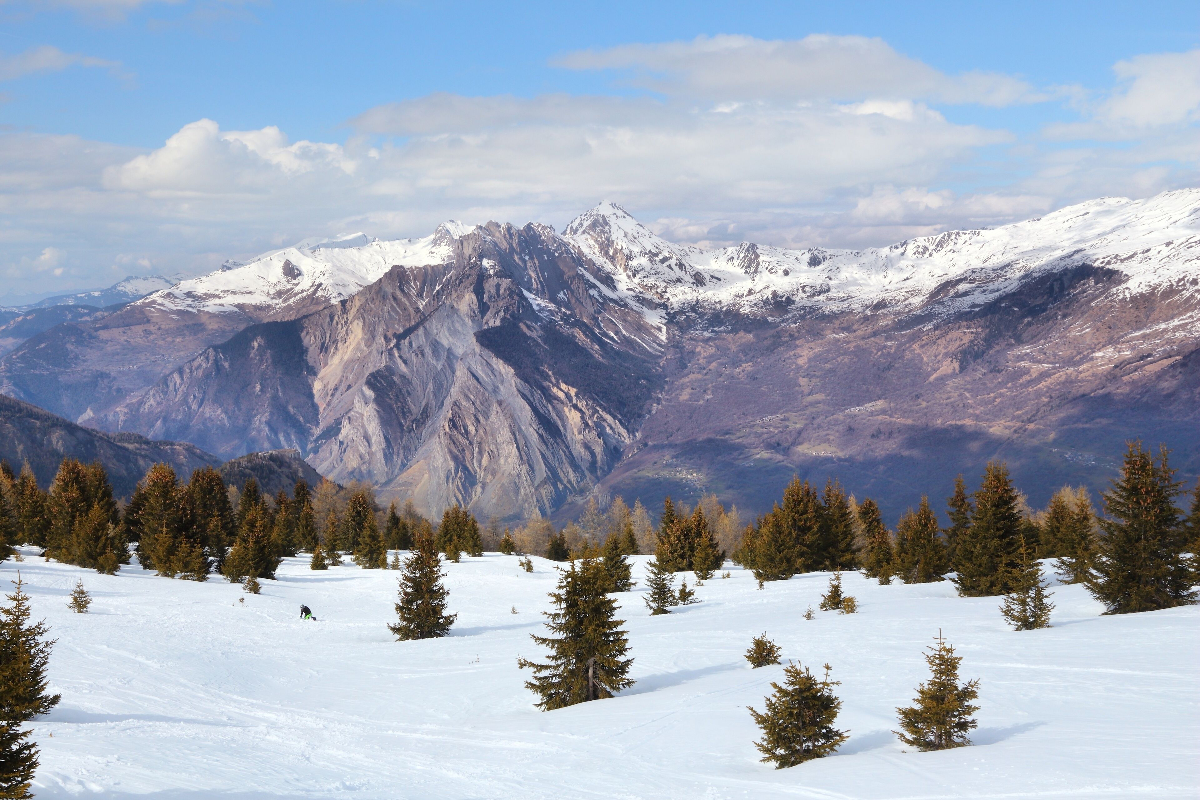 A snow-covered mountain range with a clear sky.