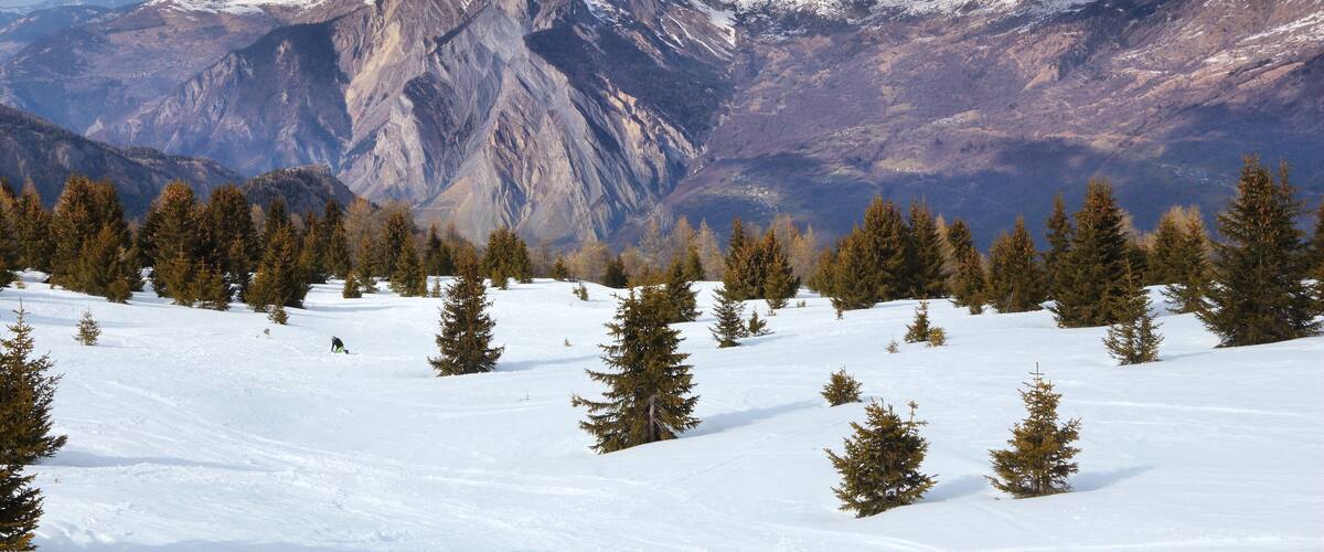 A snow-covered mountain range with a clear sky.