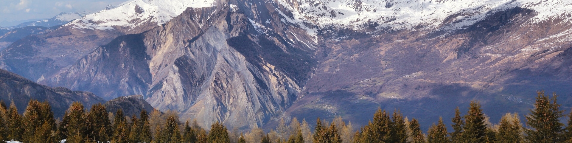 A snow-covered mountain range with a clear sky.