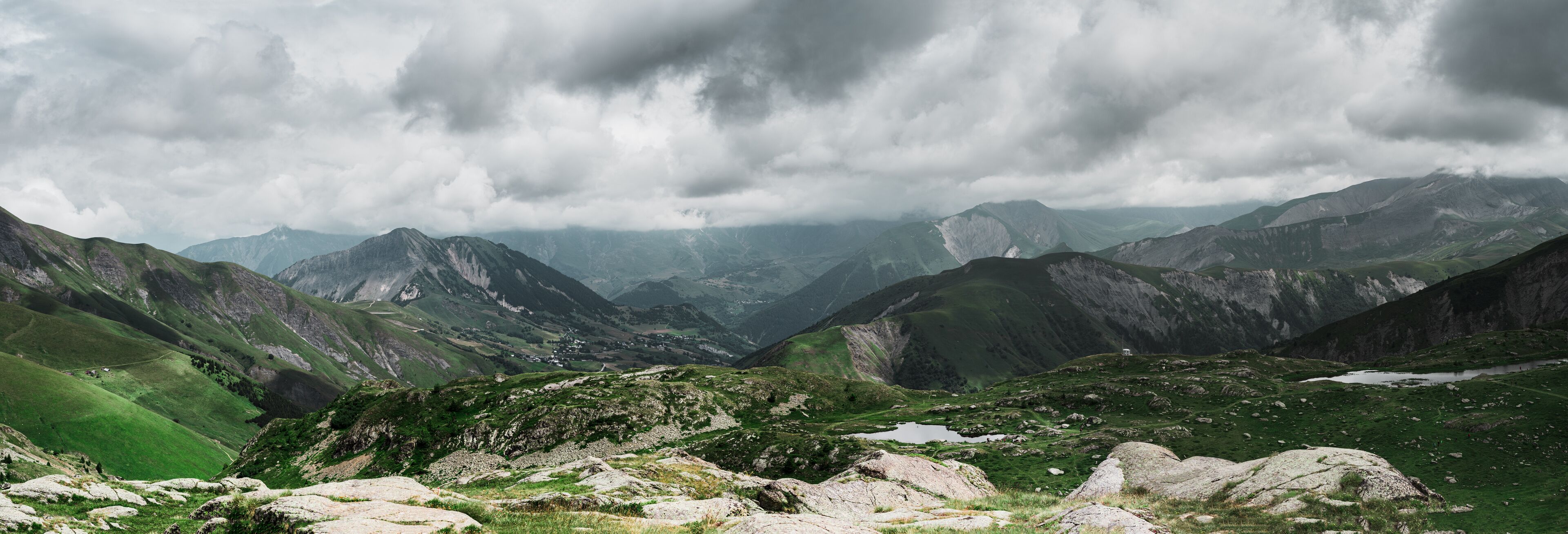 A mountainous landscape with rocky terrain and patches of green vegetation.