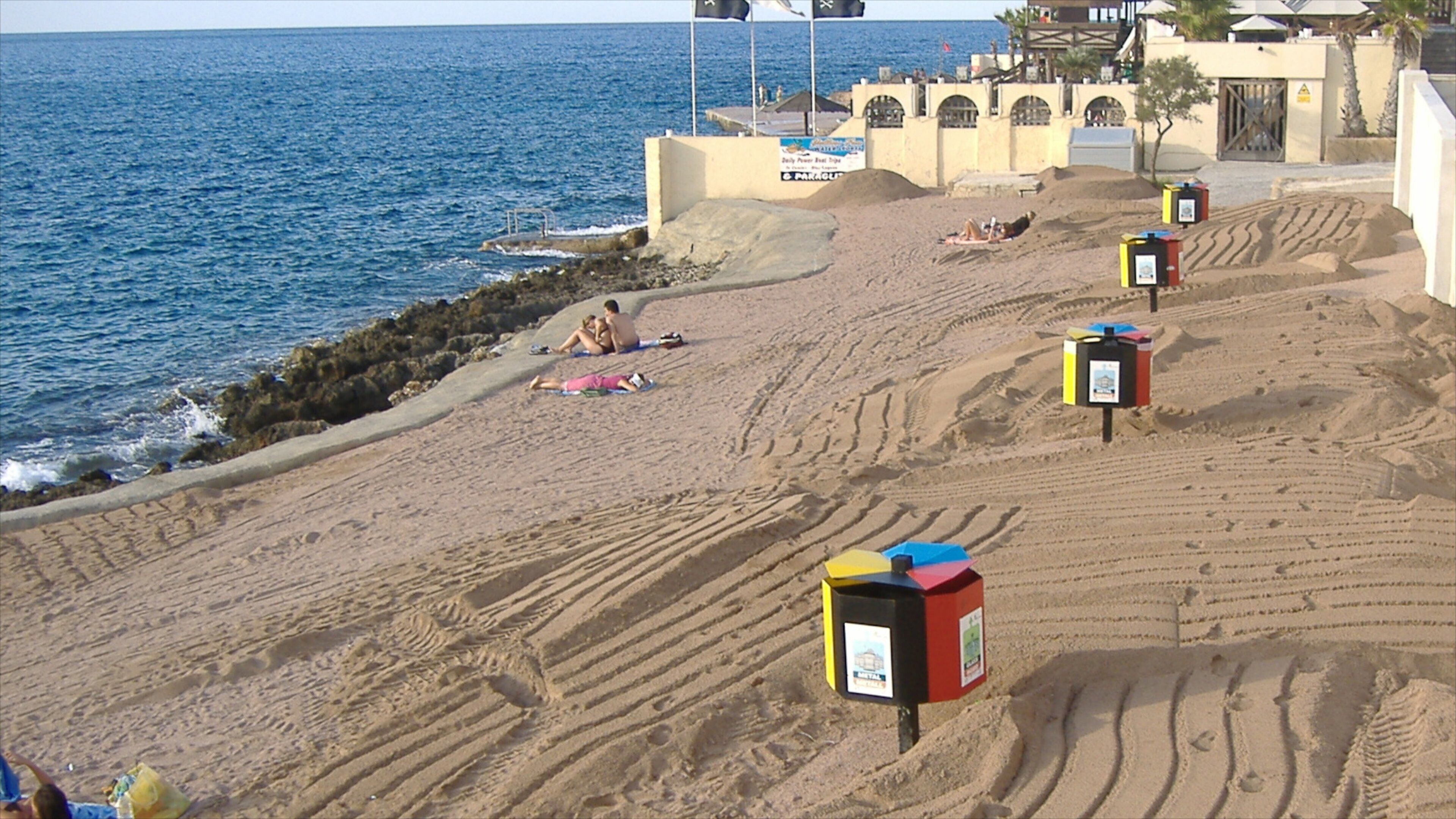 Bugibba which includes a beach, rugged coastline and general coastal views