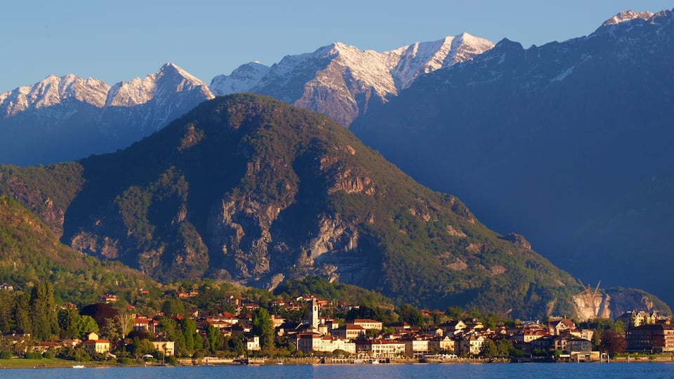 A lakeside town with a mountain backdrop.