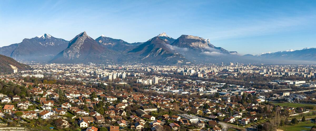 A city with residential areas and mountains in the background.