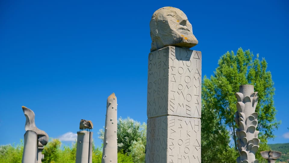 A stone monument with inscriptions and a carved head at the top.