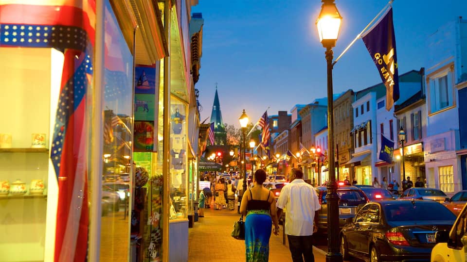 A bustling street lined with shops and flags, including a prominent 'Go Navy' banner.