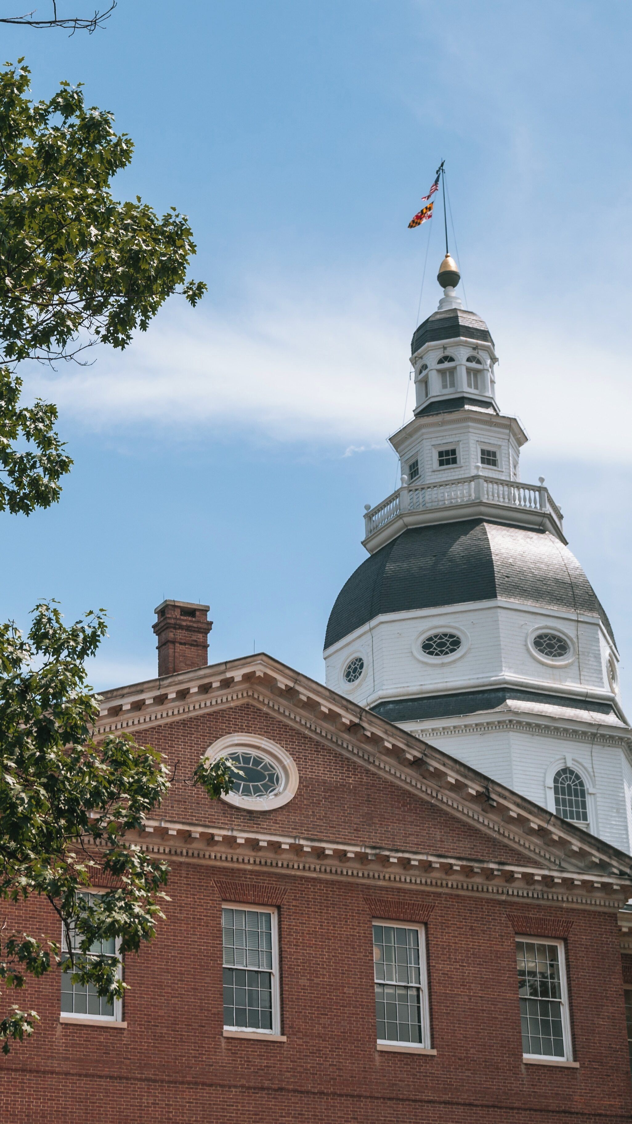 Historic Maryland State House in Annapolis showcases architecture and history against a clear blue sky in the heart of the historic district