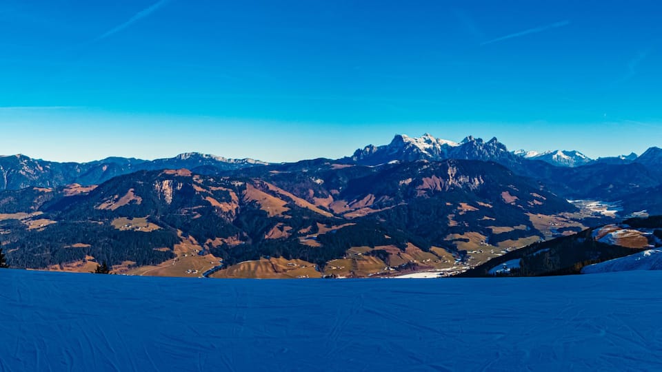 A snow-covered mountain range with clear skies.