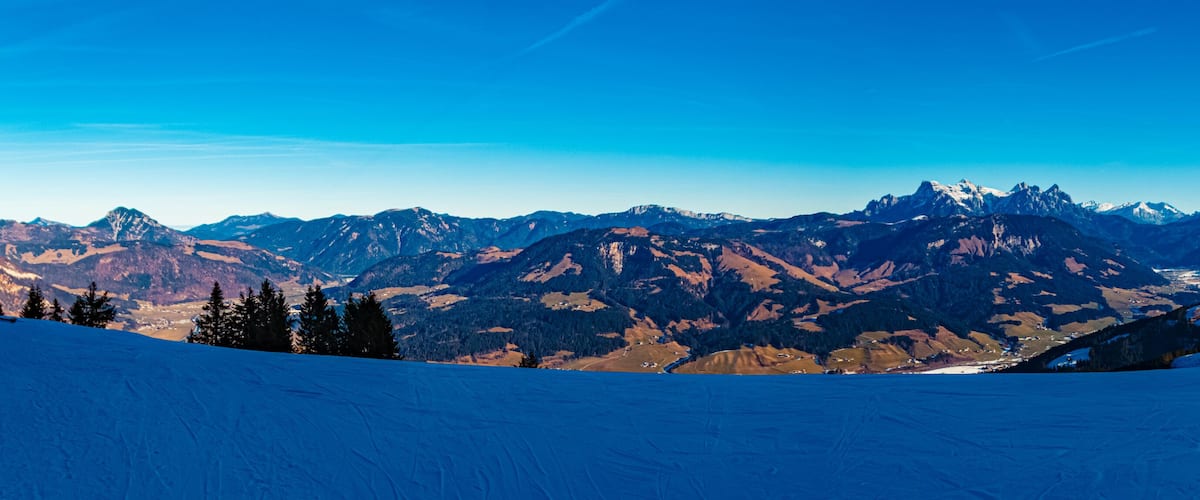 A snow-covered mountain range with clear skies.