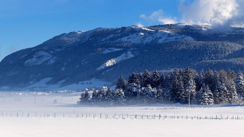 A snowy mountain landscape with a clear sky.