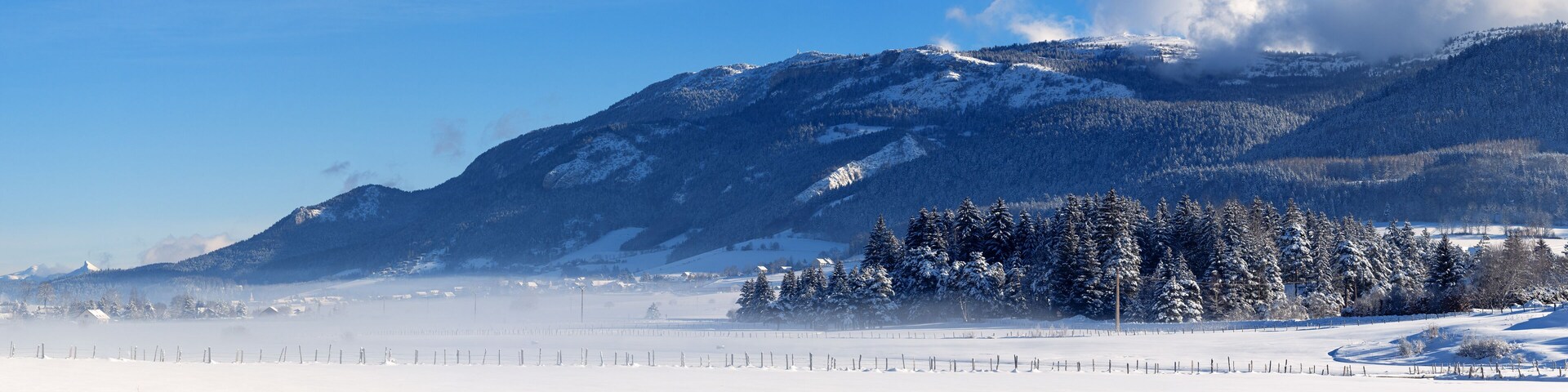 Un paisaje montañoso nevado con cielo despejado.