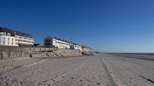 View of the beach and seafront at Fort-Mahon-Plage in the Somme department of Hauts-de-France in Northern France. Beautiful sunny spring evening with clear blue sky. Copy space above.