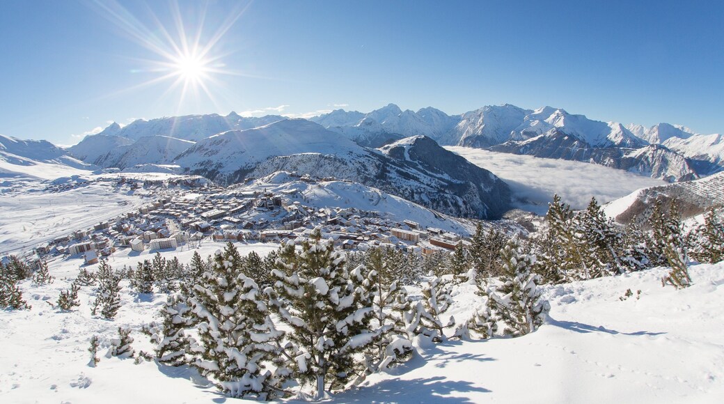 Huez showing a small town or village, snow and mountains