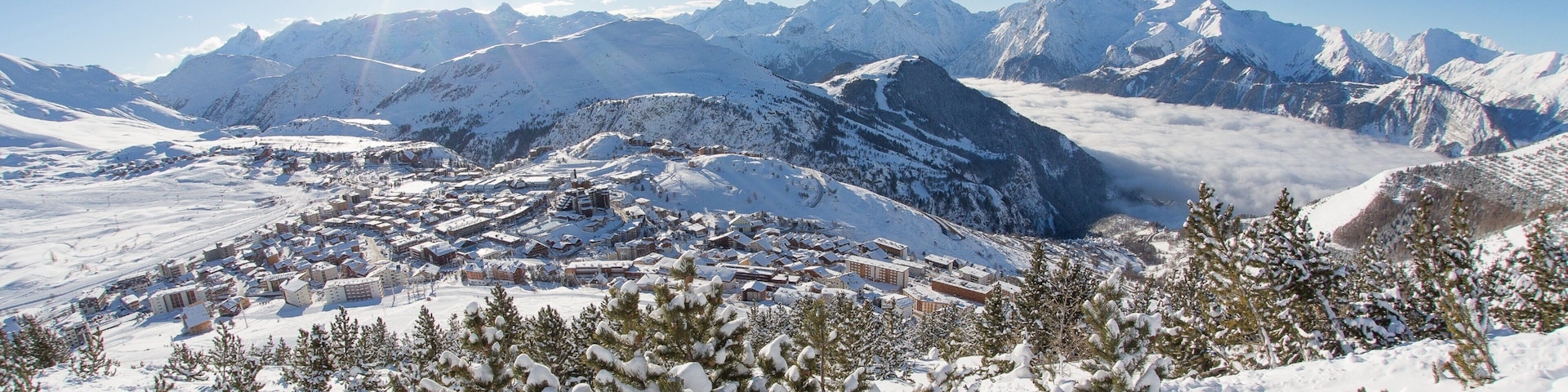 Huez showing a small town or village, snow and mountains