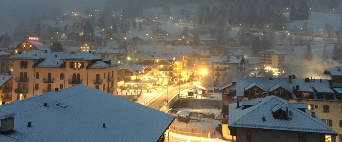 A snow-covered town with buildings and a road.