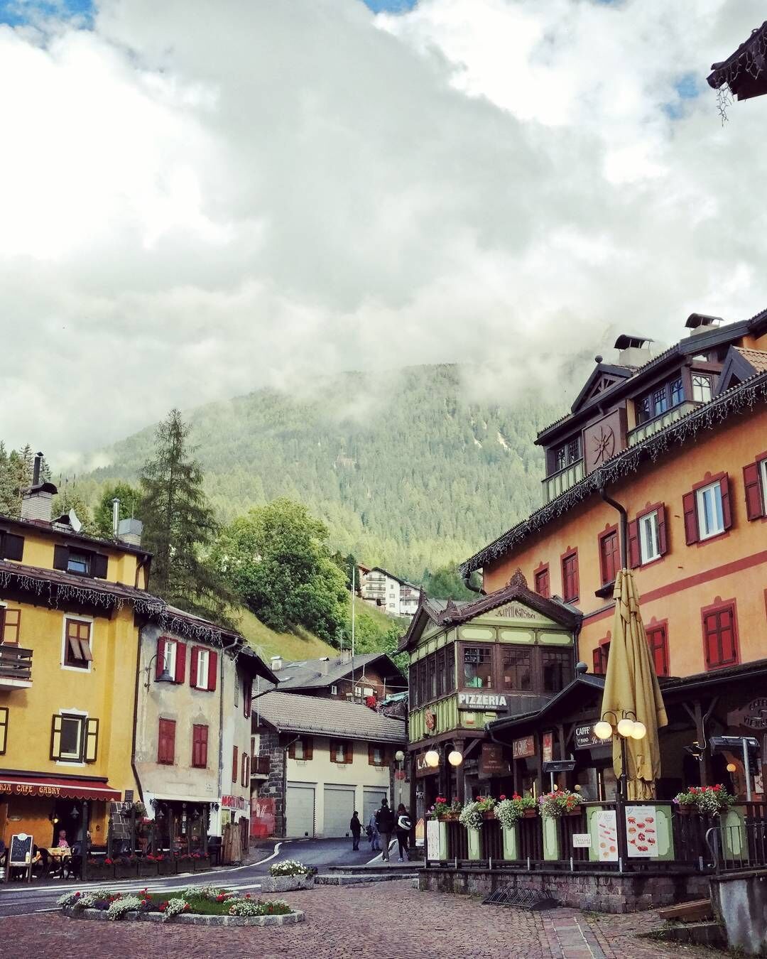 The mixed German/Italian architecture of Moena blends perfectly with the Dolomites in the background. 
#Italy #Alps #Dolomites #Merch