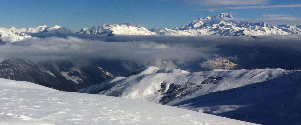 A snow-covered mountain range with a clear sky.